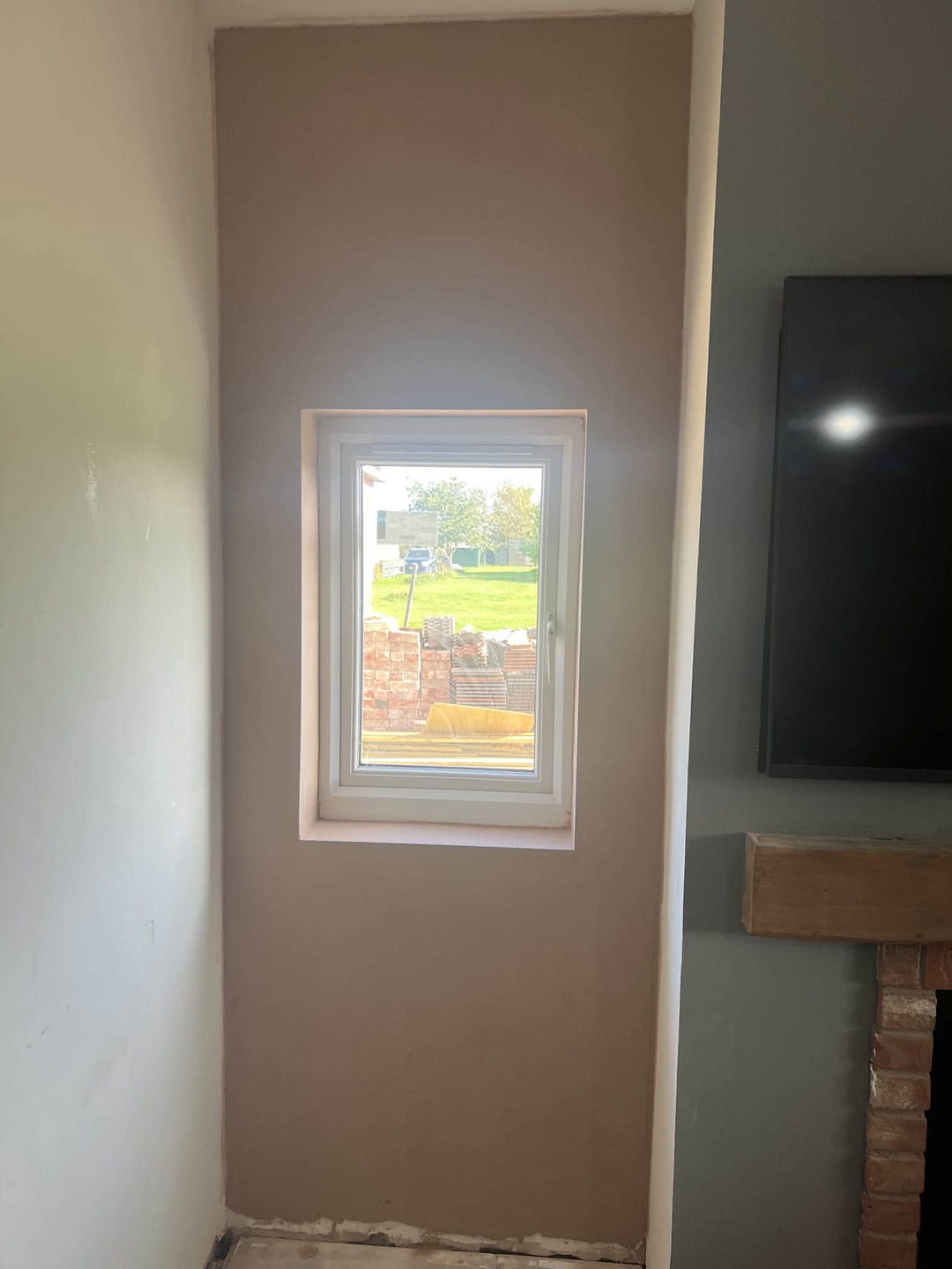 Freshly skimmed bedroom walls around a window