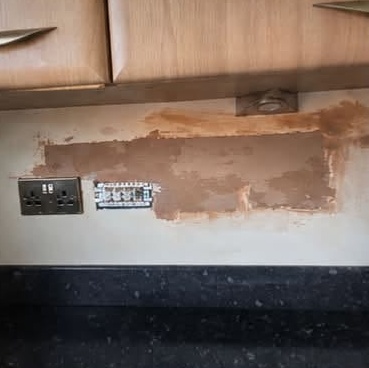 Kitchen wall patched under wall cupboards