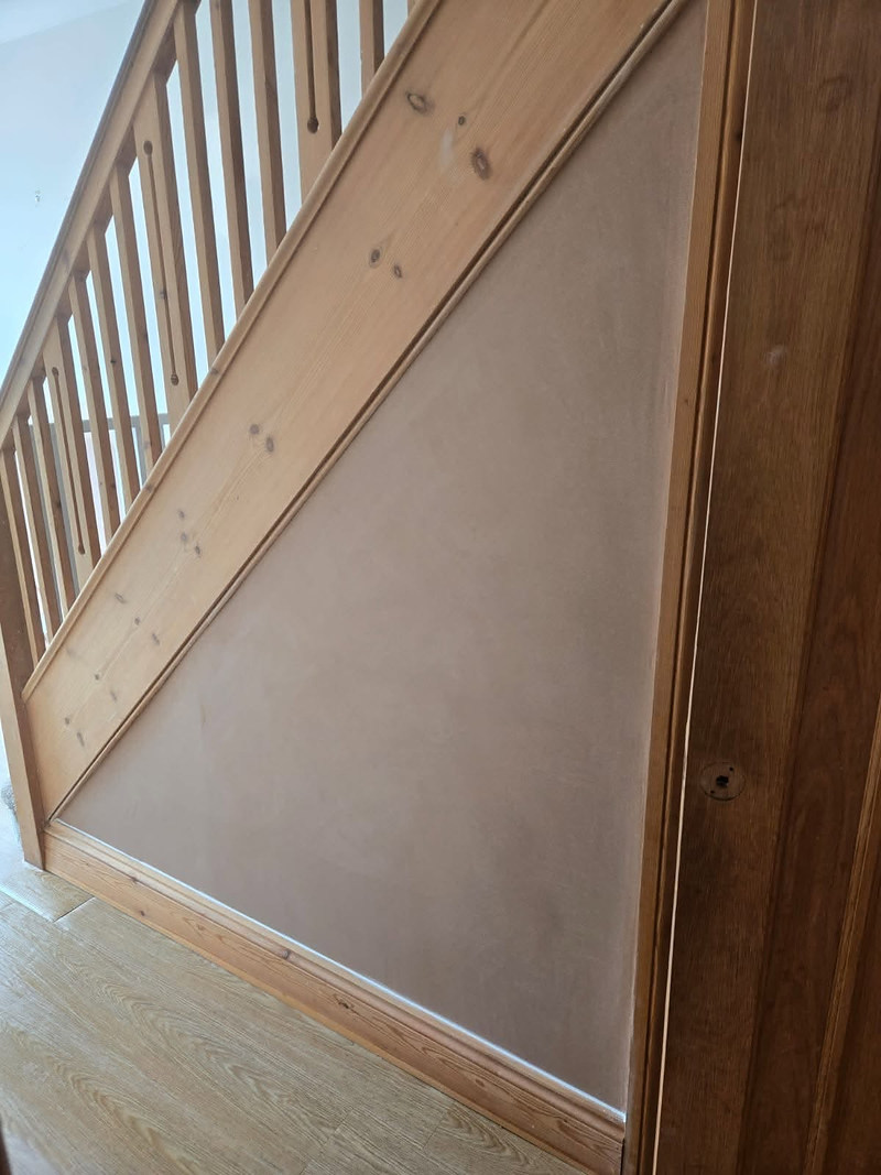 Plasterboard panel fitted under a staircase