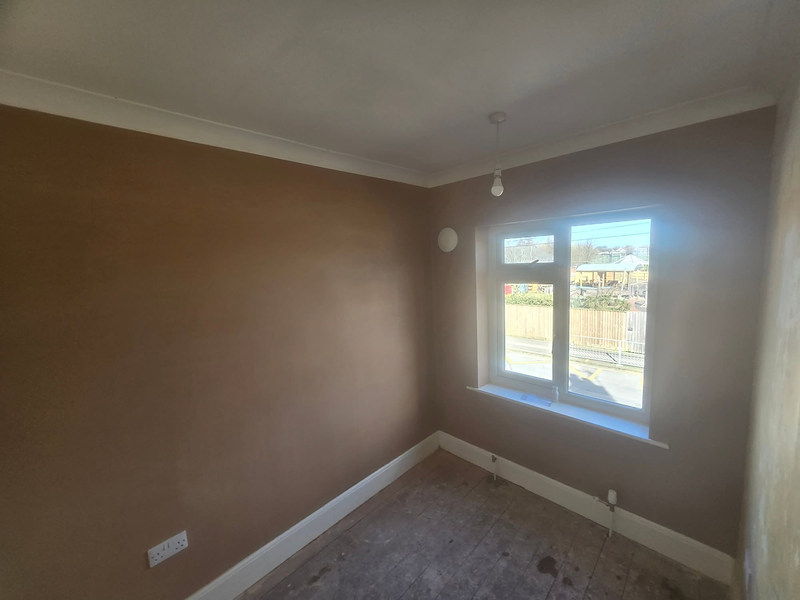 Bright skimmed bedroom with window and white skirting