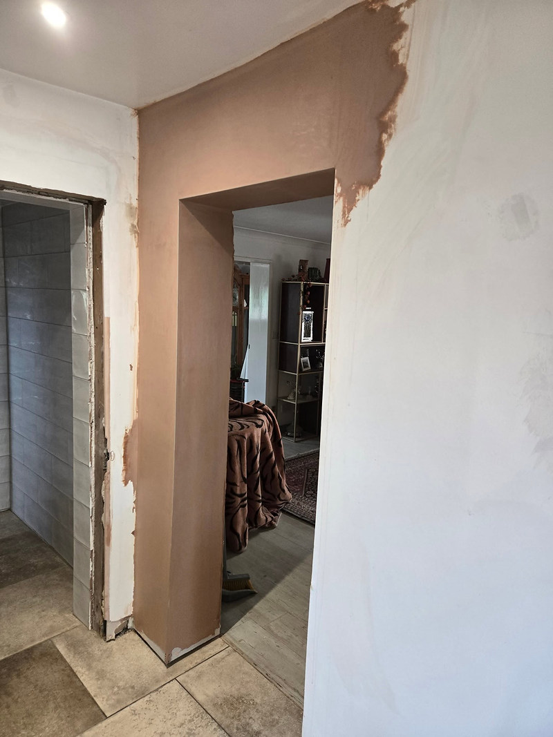 Skimmed doorway reveal with patched wall alongside
