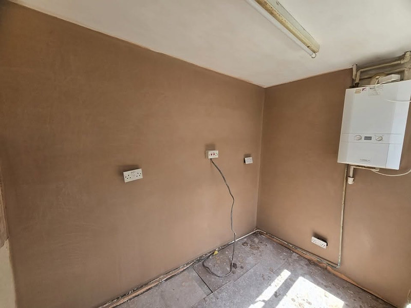 Skimmed room with wall boiler and sockets masked off